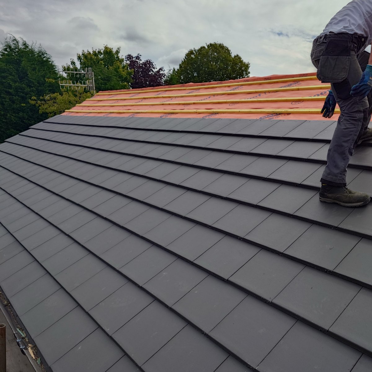 Laying flat grey tiles up a re-roof