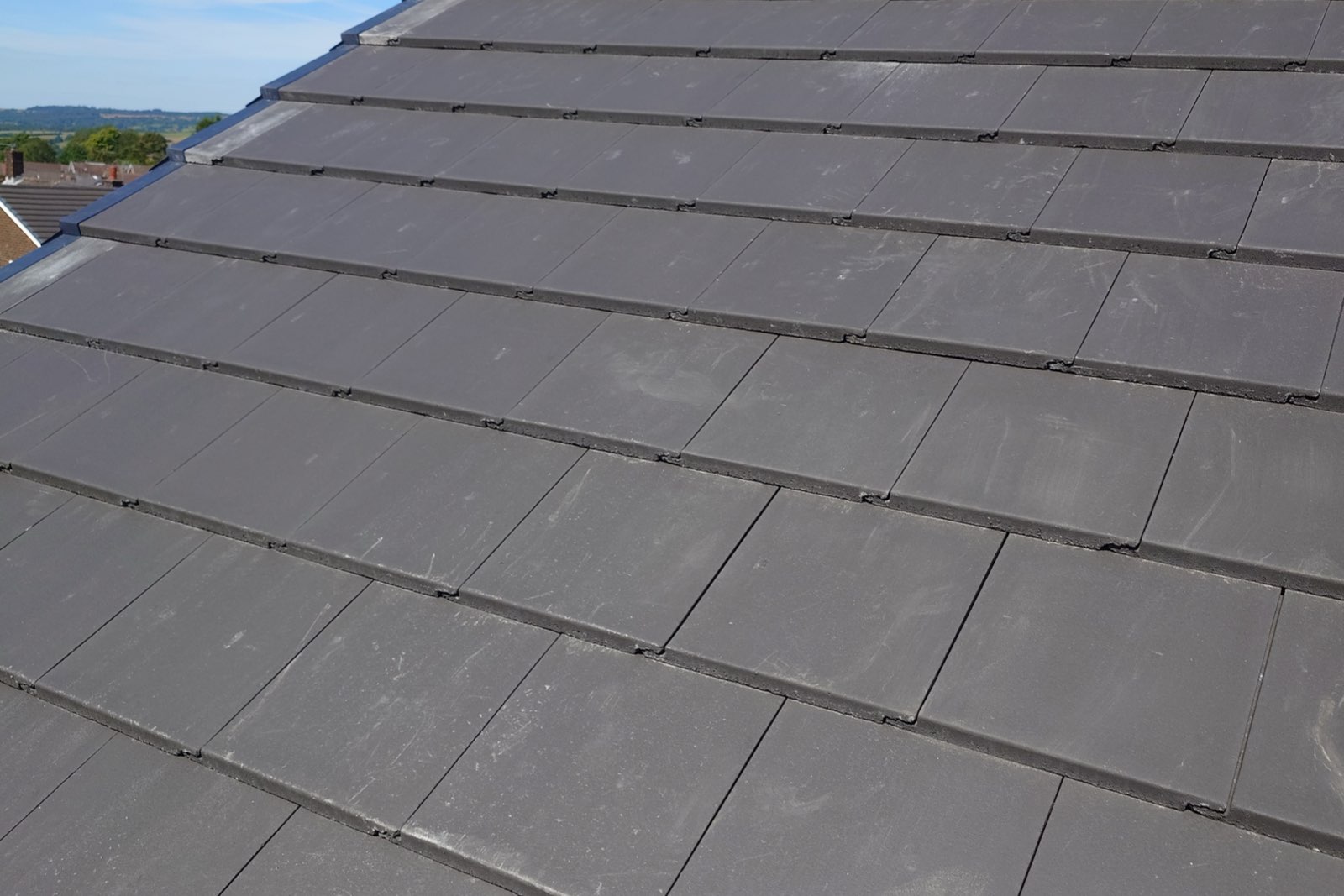 A roof finished in flat grey tiles